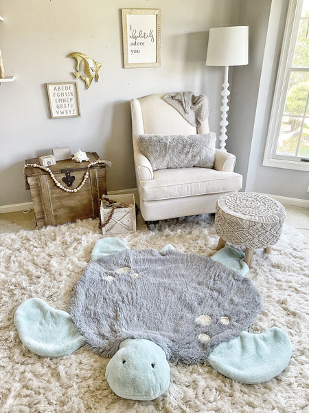 Children's room with a turtle-shaped rug made by ClaraLoo on a fluffy carpet, surrounded by furniture and decor.